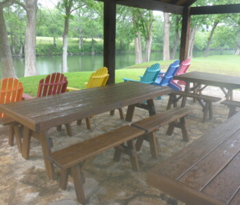 Quality Patio Furniture 8 Ft. Heavy Duty Picnic Table set up near the river for family fun. Quality Patio Furniture 8 Ft. Heavy Duty Picnic Table set up near the river for family fun with colorfully painted Adirondack chairs facing the river..