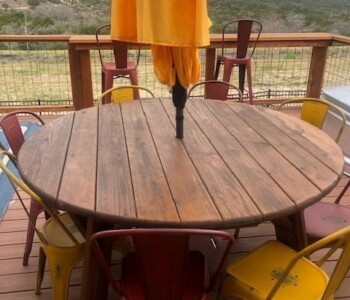 Quality Patio Furniture Round Picnic Table with hole for Umbrella pictured with metal chairs and umbrella (830) 367-3848 Round Picnic Table with hole for Umbrella pictured with Metal Chairs