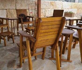 Quality Patio Furniture group of Tall Deck Chairs with Side Tables used as footstools Handcrafted by Jack Hudson (830) 367-3848 Tall Deck Chairs with Side Tables used as footstools and Tall Round Accent Tables on a stone patio Quality Patio Furniture Handcrafted by Jack Hudson (830) 367-3848